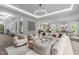 Open-concept living room featuring a modern lighting, and seamless flow to kitchen and dining areas at 2200 Paddstowe Main Way, Wake Forest, NC 27587
