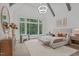 Bright main bedroom featuring a large window, beamed ceiling, and neutral decor at 2200 Paddstowe Main Way, Wake Forest, NC 27587