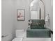 A stylish powder room features a green stone sink and elegant mirror at 2200 Paddstowe Main Way, Wake Forest, NC 27587