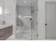 Modern shower with glass enclosure, bench, and luxurious fixtures at 2200 Paddstowe Main Way, Wake Forest, NC 27587