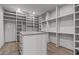 Custom walk-in closet with ample shelving and a central island for storage and organization at 2200 Paddstowe Main Way, Wake Forest, NC 27587