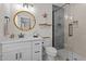 Modern bathroom with a glass-enclosed shower and a white vanity with black hardware at 2207 Otis St # B, Durham, NC 27707