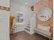 Inviting foyer features hardwood floors, stairs, and decorative mirror and wallpaper at 2207 Otis St # B, Durham, NC 27707