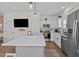 Modern kitchen featuring white cabinets, stainless steel appliances, and a spacious island at 2207 Otis St # B, Durham, NC 27707