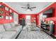 Spacious bonus room featuring bright red walls, a ceiling fan, and ample natural light at 2319 Somers Ave, Burlington, NC 27215