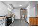 Another view of the well-lit kitchen with white cabinets, butcher block countertops and stainless appliances at 2319 Somers Ave, Burlington, NC 27215