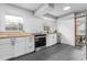 Well-lit kitchen featuring white cabinets, butcher block countertops and stainless steel appliances at 2319 Somers Ave, Burlington, NC 27215