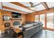 Alternate angle of cozy living room with wood paneled walls, fireplace and large sectional sofa at 2319 Somers Ave, Burlington, NC 27215
