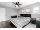 Neutral main bedroom with a plaid comforter, and ceiling fan at 2319 Somers Ave, Burlington, NC 27215
