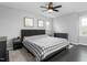 Neutral main bedroom featuring dark wood floors, ceiling fan, and playful decor at 2319 Somers Ave, Burlington, NC 27215