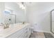 Bright bathroom with a double sink vanity, tile flooring, and a glass-enclosed shower at 241 N Nolan Park Dr, Selma, NC 27576