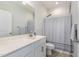 Bathroom with a white vanity, soft lighting, and a shower with a curtain at 241 N Nolan Park Dr, Selma, NC 27576