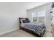 Cozy bedroom with a dark wood frame bed, carpet and one window with blinds at 241 N Nolan Park Dr, Selma, NC 27576