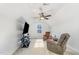 Bright bonus room with comfortable seating, ceiling fan, and plenty of sunlight at 241 N Nolan Park Dr, Selma, NC 27576