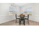Elegant dining area featuring modern table setting, chair railing, and natural light from large windows at 241 N Nolan Park Dr, Selma, NC 27576