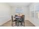 Bright dining area featuring a modern table setting, decorative wainscoting, and natural light from windows at 241 N Nolan Park Dr, Selma, NC 27576