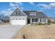 Charming single-Gathering home with a two-car garage and a well-maintained front yard under a blue sky at 241 N Nolan Park Dr, Selma, NC 27576
