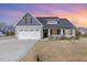 Charming single-Gathering home with a two-car garage and a well-maintained front yard under a colorful sky at 241 N Nolan Park Dr, Selma, NC 27576