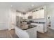 Well-lit kitchen featuring a kitchen island, stainless steel appliances and white cabinetry at 241 N Nolan Park Dr, Selma, NC 27576