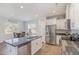 Modern kitchen with a stainless steel refrigerator and an island open to the dining area at 241 N Nolan Park Dr, Selma, NC 27576