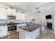 Bright, open kitchen with white cabinets, stainless steel appliances, and a granite-topped island at 241 N Nolan Park Dr, Selma, NC 27576
