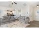 Bright, open-concept living room flowing into the kitchen, featuring neutral tones and modern furnishings at 241 N Nolan Park Dr, Selma, NC 27576