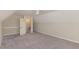 Upper floor bedroom featuring carpeted floors, a ceiling fan, and a door that leads to extra storage at 2440 Us 70 A, Selma, NC 27576