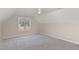 Attic bedroom with carpeted floors, neutral colors, and a bright window providing ample light at 2440 Us 70 A, Selma, NC 27576