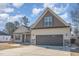 Charming two-story home featuring a two-car garage, landscaped yard and inviting front porch at 2440 Us 70 A, Selma, NC 27576