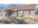 Back exterior featuring a covered patio with a swing, complemented by neutral siding and a well-maintained yard at 2440 Us 70 A, Selma, NC 27576