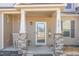 Inviting front porch with stone pillars, a rocking chair, and a charming 'Home Sweet Home' sign at 2440 Us 70 A, Selma, NC 27576