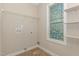 Well-lit laundry room with shelving, connections and unique window, offering convenience and style at 2440 Us 70 A, Selma, NC 27576