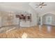 Open-concept living room and kitchen with wood floors, stylish lighting, and a breakfast bar at 2440 Us 70 A, Selma, NC 27576