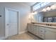 Bright bathroom featuring a double vanity with granite countertop and large mirror at 2620 Club Level Dr, Apex, NC 27523