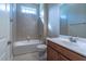 Well-lit bathroom features a tiled shower and tub, single vanity, and neutral color palette at 2620 Club Level Dr, Apex, NC 27523