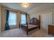 Bedroom with carpet flooring, natural light from the windows, and 4 post wooden bed frame at 2620 Club Level Dr, Apex, NC 27523
