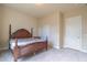 Bedroom featuring neutral carpet, matching wood furnishings, and a double door closet at 2620 Club Level Dr, Apex, NC 27523