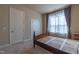 Bedroom featuring neutral carpet, matching wood furnishings, and a double door closet at 2620 Club Level Dr, Apex, NC 27523