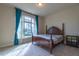 Bright bedroom featuring a large window, neutral walls, carpet, and classic furnishings at 2620 Club Level Dr, Apex, NC 27523