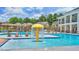 Community pool area with splash pad, lounge chairs, and clear sight lines to the clubhouse at 2620 Club Level Dr, Apex, NC 27523