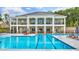 Community pool with separate swimming areas, lounge chairs, and a covered patio at 2620 Club Level Dr, Apex, NC 27523