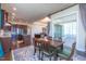 Open-concept dining and living area with modern kitchen and access to a covered patio at 2620 Club Level Dr, Apex, NC 27523