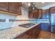 Gourmet kitchen featuring granite counters, tiled backsplash, and stainless gas range at 2620 Club Level Dr, Apex, NC 27523