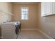 Well-lit laundry room featuring modern appliances and ample shelving for organized storage at 2620 Club Level Dr, Apex, NC 27523
