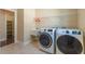 Spacious laundry room equipped with a sink, modern washer, and dryer for convenience at 2620 Club Level Dr, Apex, NC 27523