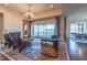 Bright living room with fireplace, leather chairs, and balcony access at 2620 Club Level Dr, Apex, NC 27523