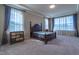 Spacious main bedroom with tray ceiling, large windows, and elegant decor at 2620 Club Level Dr, Apex, NC 27523