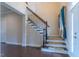 Staircase with decorative wood and wrought iron accents, natural light, and neutral wall colors at 2620 Club Level Dr, Apex, NC 27523