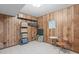 Wood-paneled basement featuring tile floor and shelving at 2808 Newquay St, Durham, NC 27705