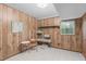 Basement room with wood-paneled walls, tile floor and window at 2808 Newquay St, Durham, NC 27705